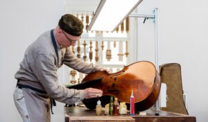 ein Mann, der an einem Cello arbeitet